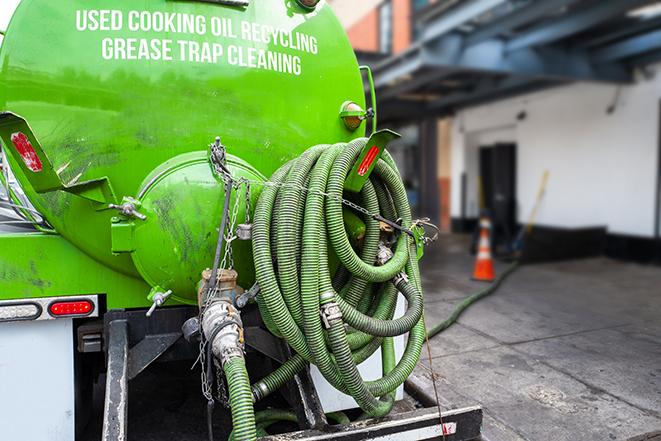 a grease trap being pumped by a sanitation technician in Plantation